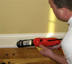 Installing Insulation in a wall in a Cuyahoga Falls home for increased energy efficiency